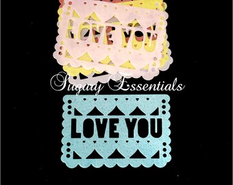 May include: A stack of pastel-colored paper cutouts with the words "LOVE YOU" in a decorative font. The cutouts have scalloped edges and heart-shaped details. The text "Sugary Essentials" is also visible.
