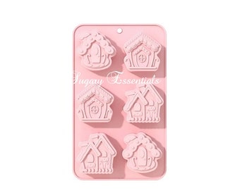 May include: Pink silicone mold with six cavities shaped like gingerbread houses. The mold is designed for making candy, chocolate, or soap.