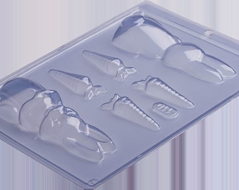 May include: A clear plastic mold for making chocolate bunnies and carrots. The mold has five cavities: one large bunny, one smaller bunny, and three carrots.
