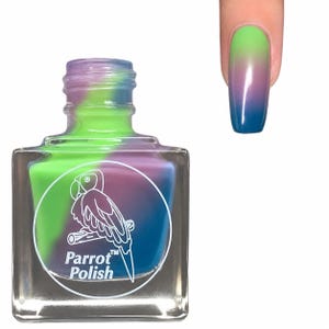 May include: A clear glass bottle of Parrot Polish nail varnish with a colour-changing effect. The varnish transitions from green to purple to blue. The bottle features a parrot logo and the brand name. A painted nail shows the colour gradient.