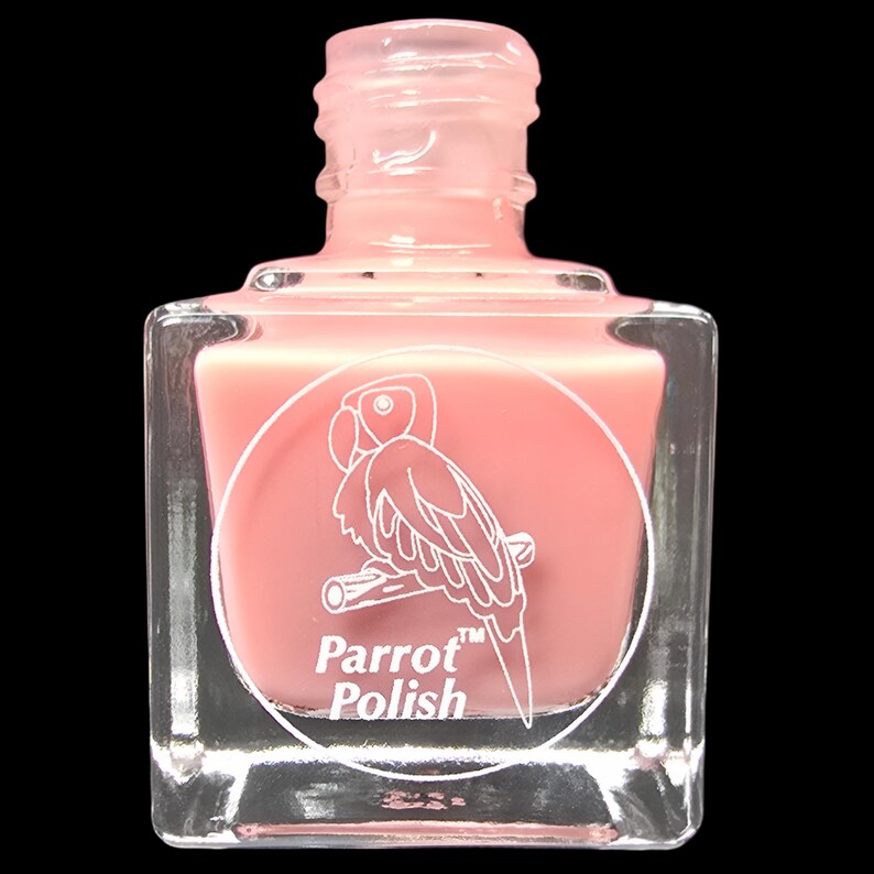 May include: A clear, square nail polish bottle filled with a light pink polish. The bottle features a white circular label with a parrot illustration and the words "Parrot Polish". The bottle has a clear, pink cap.