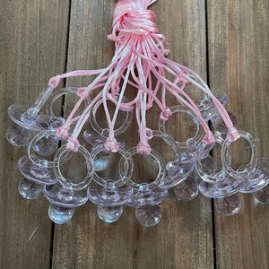 baby shower pacifiers party favor decorations for game - 12pc clear pacifier necklaces with pink rattail cord - baby shower craft supply