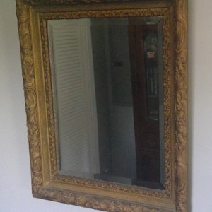 Ornate carved wooden frame beveled mirror
