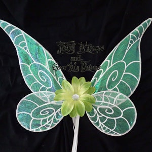 May include: Green and white fairy wings with a green flower attached to the center. The wings have a shimmery iridescent finish.