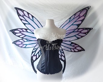 May include: Purple and blue iridescent fairy wings with a black corset. The wings are made of sheer fabric with glitter accents. The corset has a lace trim.