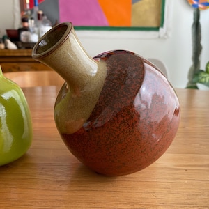 A ceramic vase with a round body.