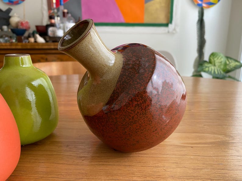 A ceramic vase with a round body.