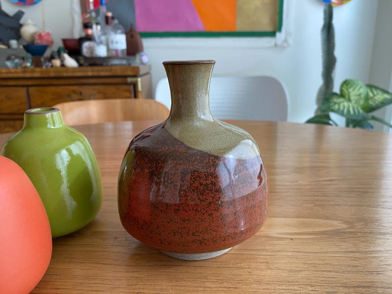 A ceramic vase with a rounded body and a narrow neck.