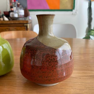 A ceramic vase with a rounded body and a narrow neck.