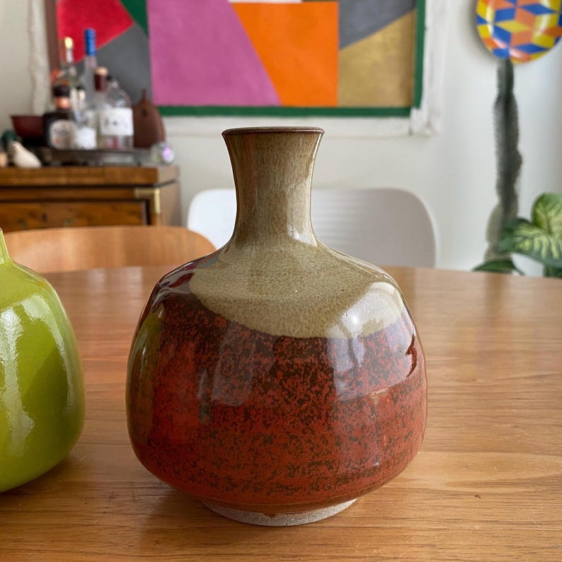 A ceramic vase with a rounded body and a narrow neck.