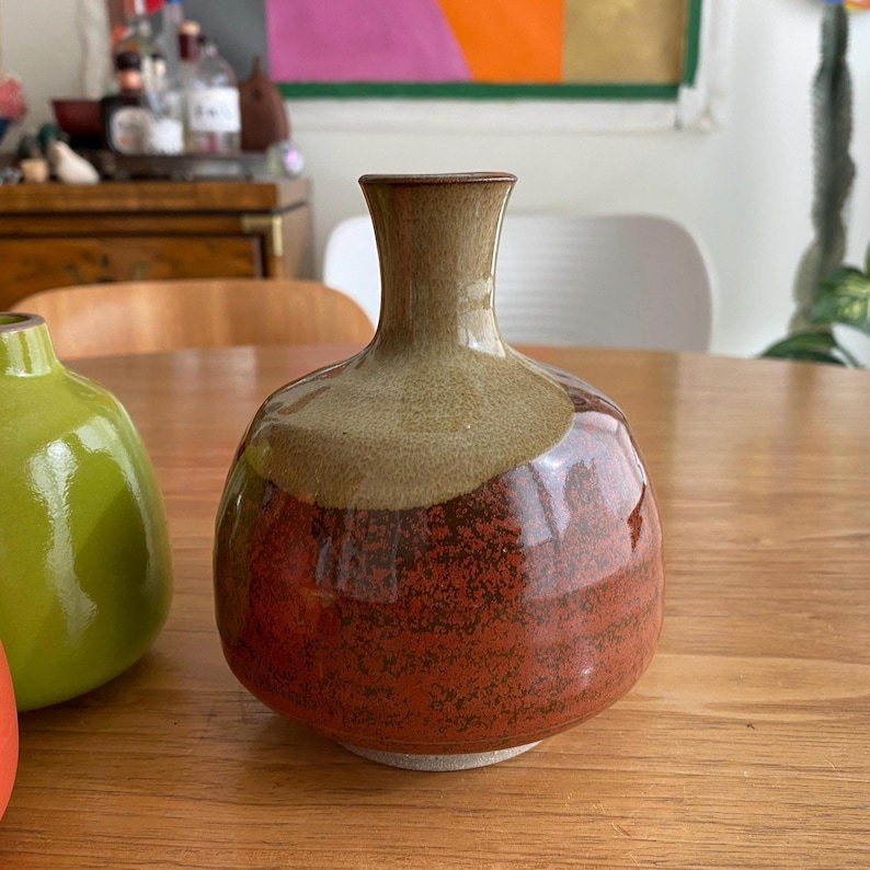A ceramic vase with a rounded body and a narrow neck.