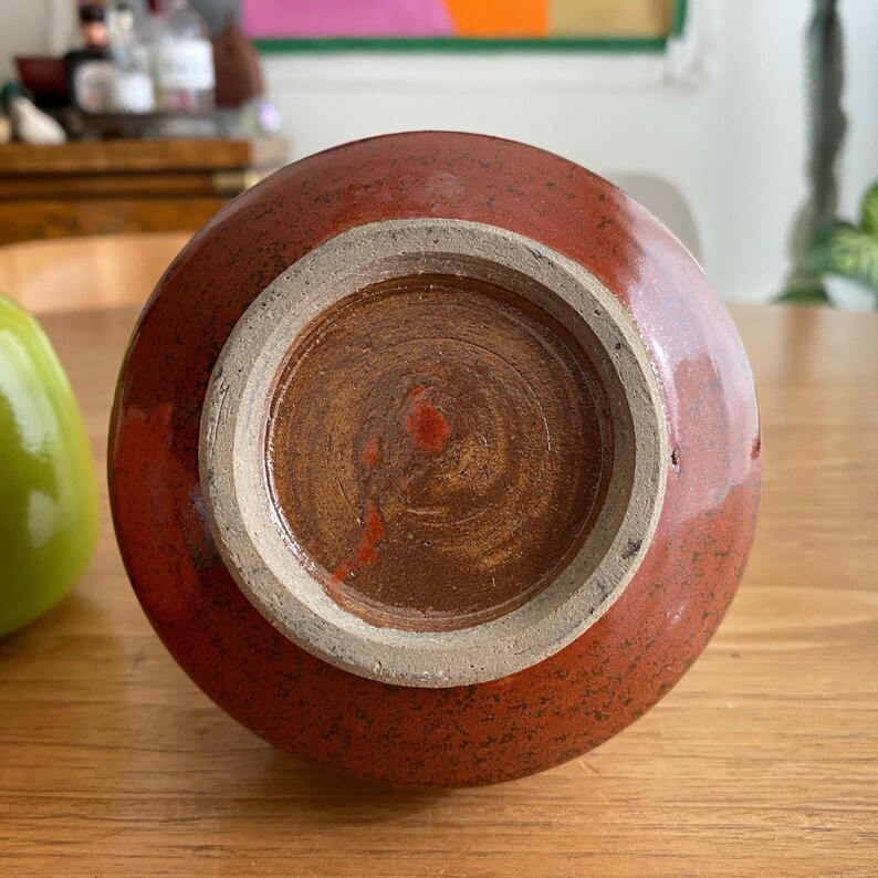 A handmade, round ceramic vase.