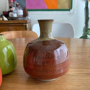 A ceramic vase with a rounded body and a narrow neck.
