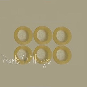 May include: Six round, beige, rubber grommets with a hole in the center.