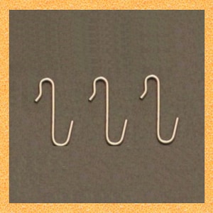 May include: Three silver-colored metal hooks with a simple, curved design.