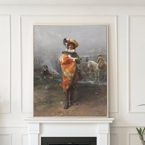 May include: A living room interior featuring a framed painting above a fireplace. Two emerald green velvet armchairs with gold bases are positioned around a glass coffee table. Decorative plants and white walls complete the scene.