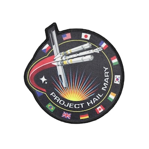 May include: Embroidered patch with a black background featuring a spacecraft design and the text "PROJECT HAIL MARY". The patch includes a ring of international flags and the name "MARY".