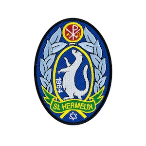 May include: A blue and green embroidered patch with a white weasel, a yellow banner with the text "1964" and the text "St. Hermelin" on a green banner. The patch also features a red and yellow symbol with a cross.