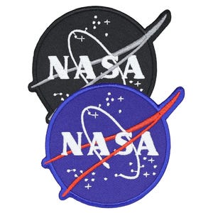 May include: Two embroidered patches featuring the NASA logo. One patch is black with white text and a silver swoosh, the other is blue with white text and a red swoosh. Both patches have a circular shape.