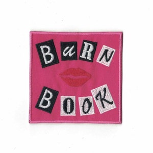 May include: Pink square patch with the words "BARN BOOK" in black and white letters, with a red lip print in the center.