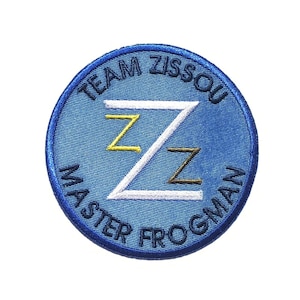May include: Blue embroidered patch with the text "Team Zissou Master Frogman" and a white stylized letter Z with a yellow and black Z inside.