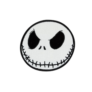 May include: Black and white embroidered patch of Jack Skellington's face from the Nightmare Before Christmas movie.
