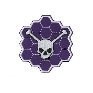 May include: Purple embroidered patch with a white skull and crossbones design. The skull has black eyes and a black nose. The background is a honeycomb pattern.