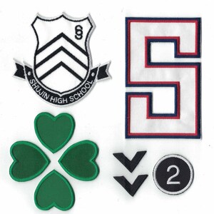 May include: A set of five iron-on patches. The patches are black, white, red, blue, and green. The patches include a school crest with the text "Shujin High School", a number "5", a four-leaf clover, two black arrows, and a black circle with the number "2" inside.