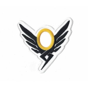 May include: Black and gold embroidered patch featuring a winged symbol with a lightning bolt. The symbol is encircled by a gold ring.