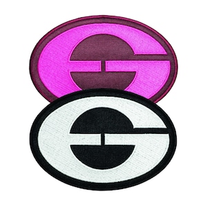 May include: Two oval-shaped embroidered patches featuring a stylized letter G. The top patch has a bright pink letter G on a dark maroon background. The bottom patch features a white letter G on a black background, with a thick black border.