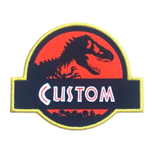 May include: A yellow and black embroidered patch with a red dinosaur silhouette and the word "CUSTOM" in white letters.