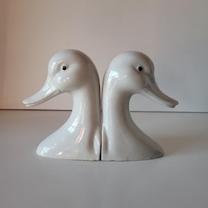 Porcelain bookends with goose heads.