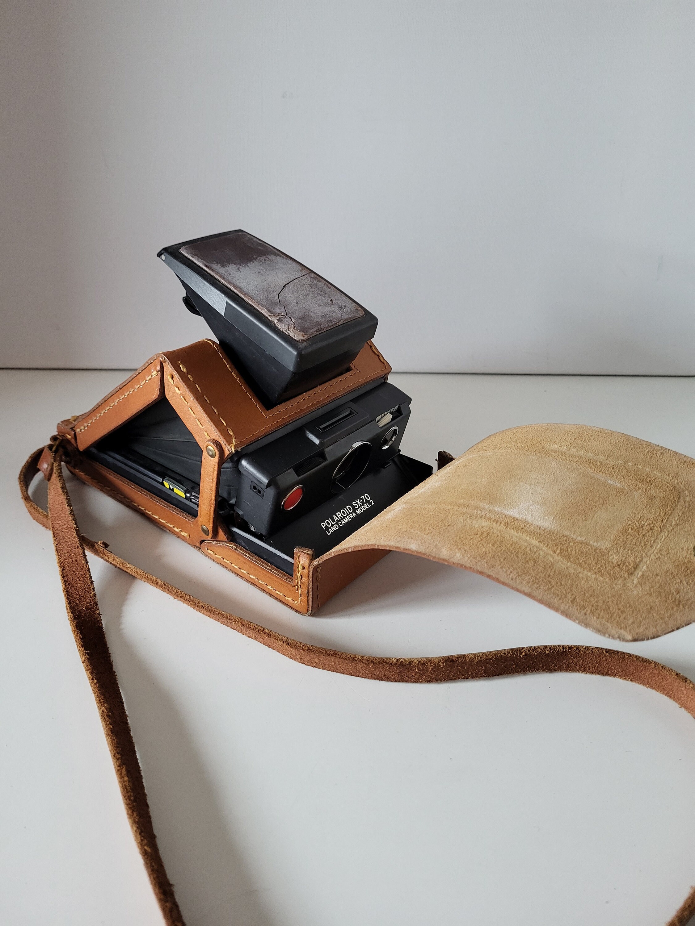 A Polaroid SX-70 Land Camera w/ Original Leather Case