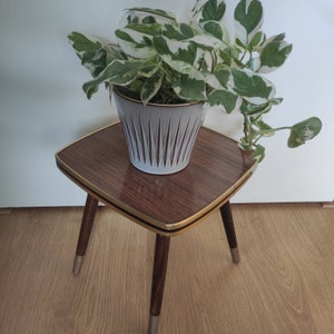 Cute little square 1960s table with a faux wood top. Plant table.