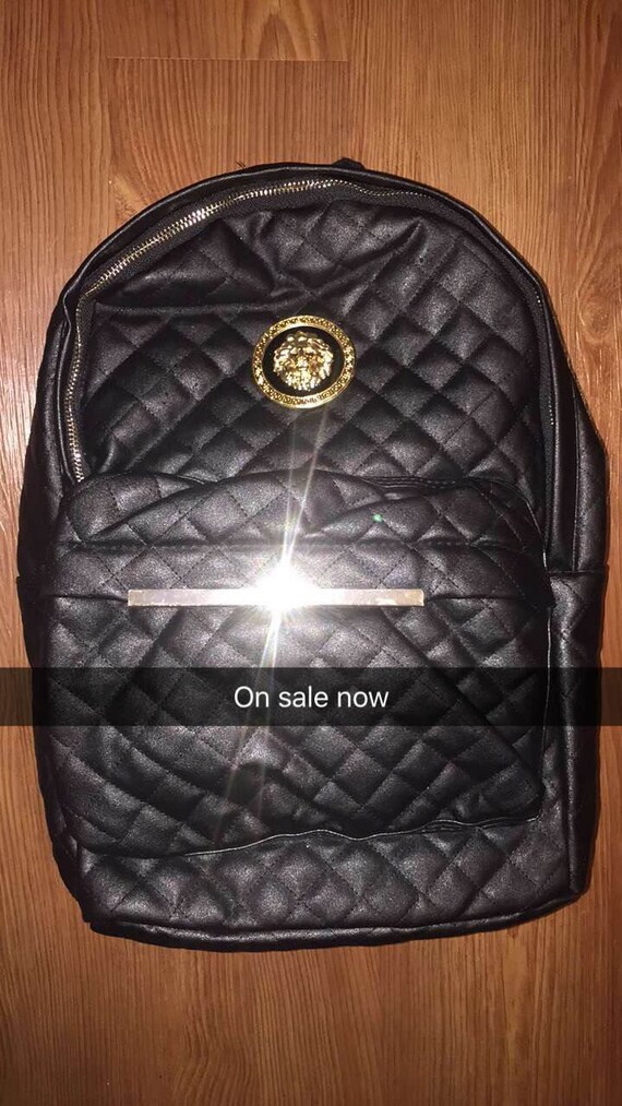 Items similar to Quilted Black leather & Gold badge backpack on Etsy