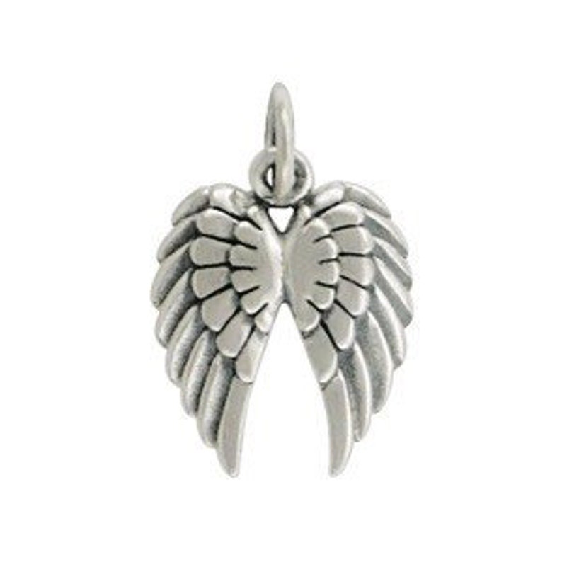 May include: A silver-colored angel wing pendant. The pendant features detailed feather textures and a small loop at the top for attaching to a chain. The wings are spread open, showcasing the intricate design.