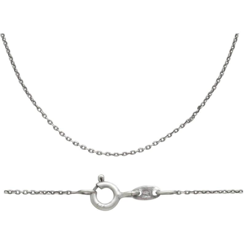 May include: A silver chain necklace with a lobster clasp.