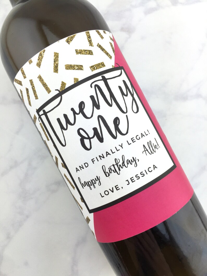 May include: A white wine bottle label with a black and gold geometric pattern. The label says "twenty one" and "AND FINALLY LEGAL! happy birthday, Allie! LOVE, JESSICA".
