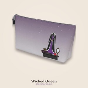 May include: A zippered cosmetic bag with a purple and white gradient background. The bag features a cartoon illustration of a black and purple gown, a crown, a mirror, and an apple. The text "Wicked Queen" is at the bottom.