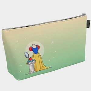 May include: A cosmetic bag with a zipper closure and a gradient background of yellow and green. The bag features an illustration of a Snow White dress, a mirror, and an apple. The design includes a white pillar and a full moon.
