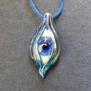 Glass white flecked blue eye pendant. comes with satin cord of your choice. Metallic blue colored glass eyelid