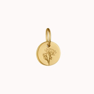 May include: A gold-colored, circular pendant with a floral design. The pendant features a small loop at the top for attaching to a chain. The flower is etched into the surface of the pendant. The pendant is a jewelry item.
