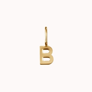 May include: Gold letter B charm pendant. The letter is hollow and has a simple, modern design.