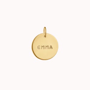 May include: Gold-colored round disc pendant with the name "EMMA" engraved on it.