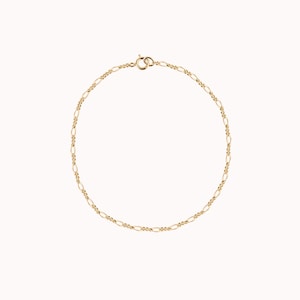 May include: A gold chain bracelet with a lobster clasp.