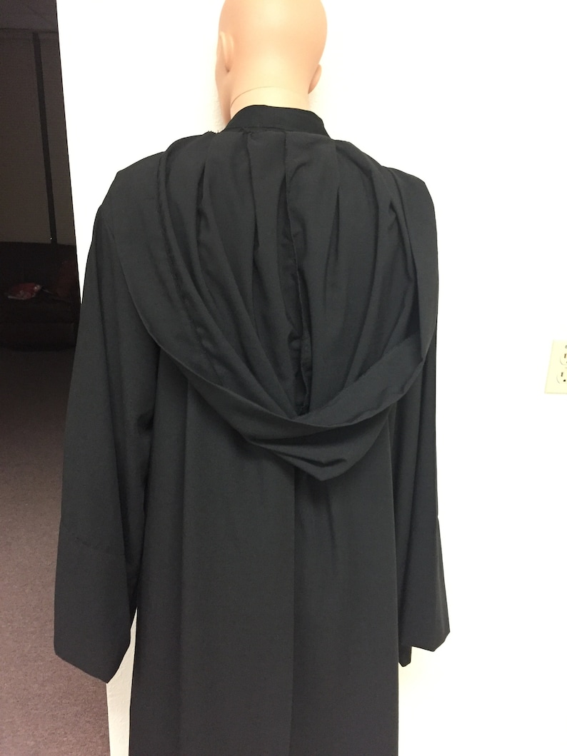 May include: Black hooded robe with a pleated back and long sleeves.