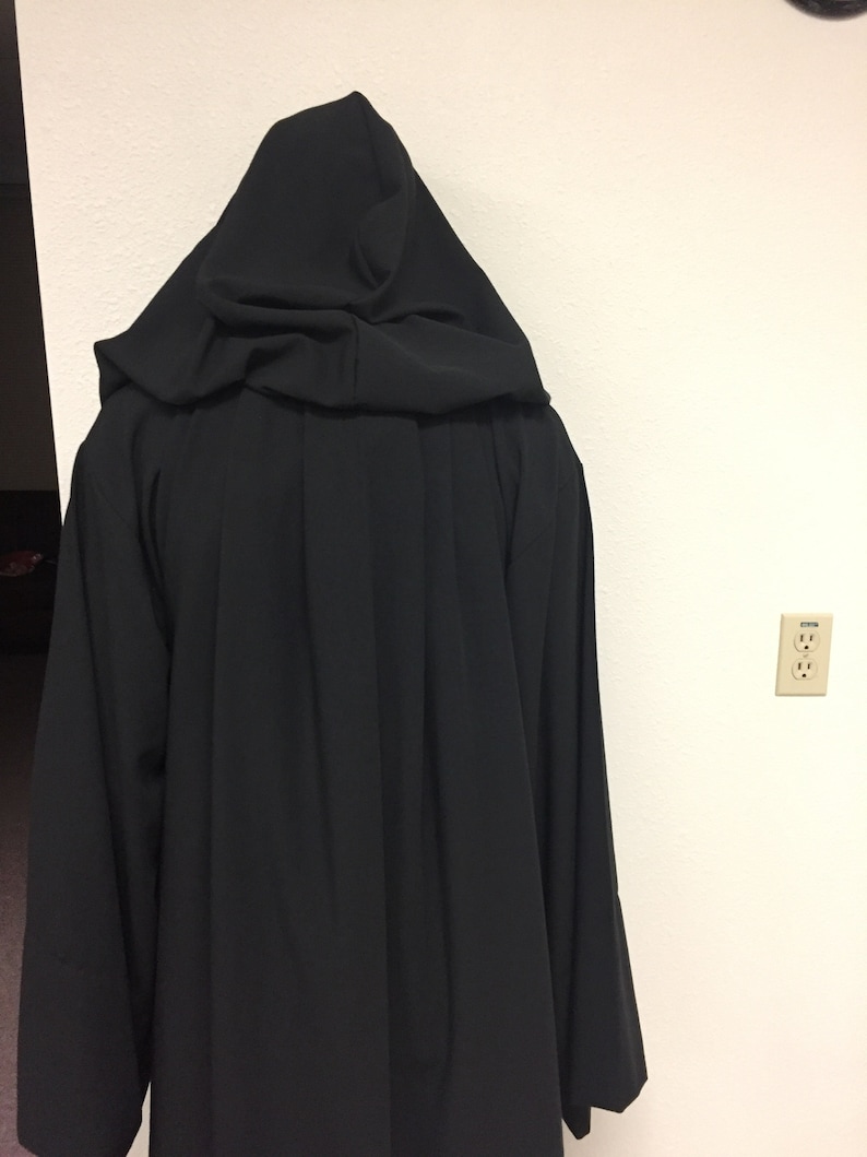 May include: A black hooded robe with a long, flowing design. The robe is made of a soft, smooth fabric.