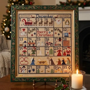 May include: A framed cross-stitch calendar for December featuring a grid of 31 squares. Each square contains small holiday-themed icons, including a sleigh, reindeer, gifts, a snowman, and nativity figures. The text reads December and Merry Christmas.