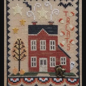 May include: Cross-stitch sampler featuring a red house with a black roof, surrounded by Halloween-themed elements. The word "TREATS" is stitched vertically. Includes stars, a tree, pumpkins, a ghost, and a decorative border.