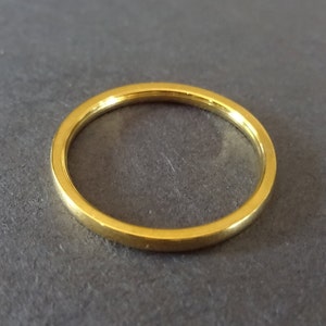 May include: A simple gold ring, a classic and timeless piece of jewelry.